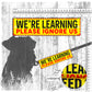 "WE'RE LEARNING, space ignore us". Warning leash sleeves for dog training.